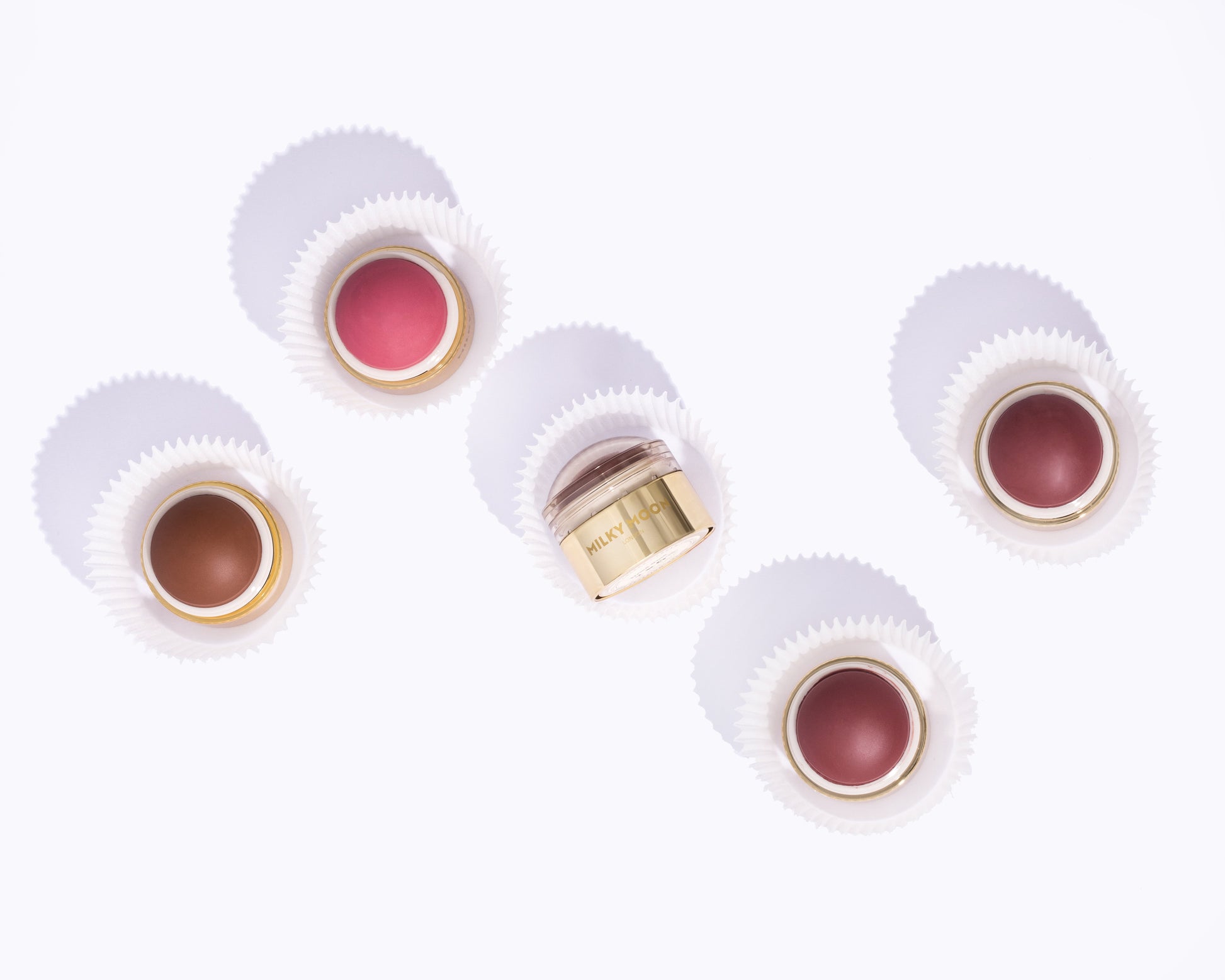 Set of lip products with visible brand on a white background
